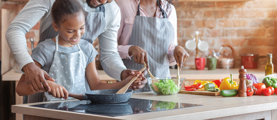 family cooking in kitchen